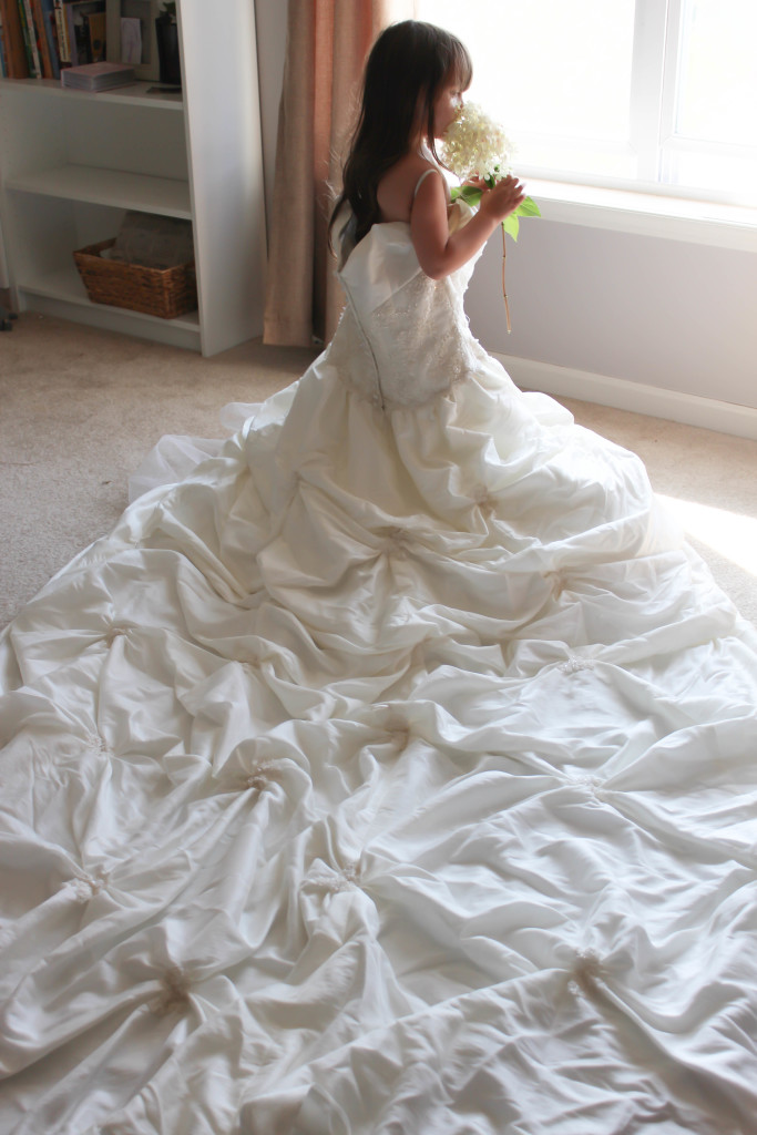 Take photos of your daughter playing dress up in your wedding dress